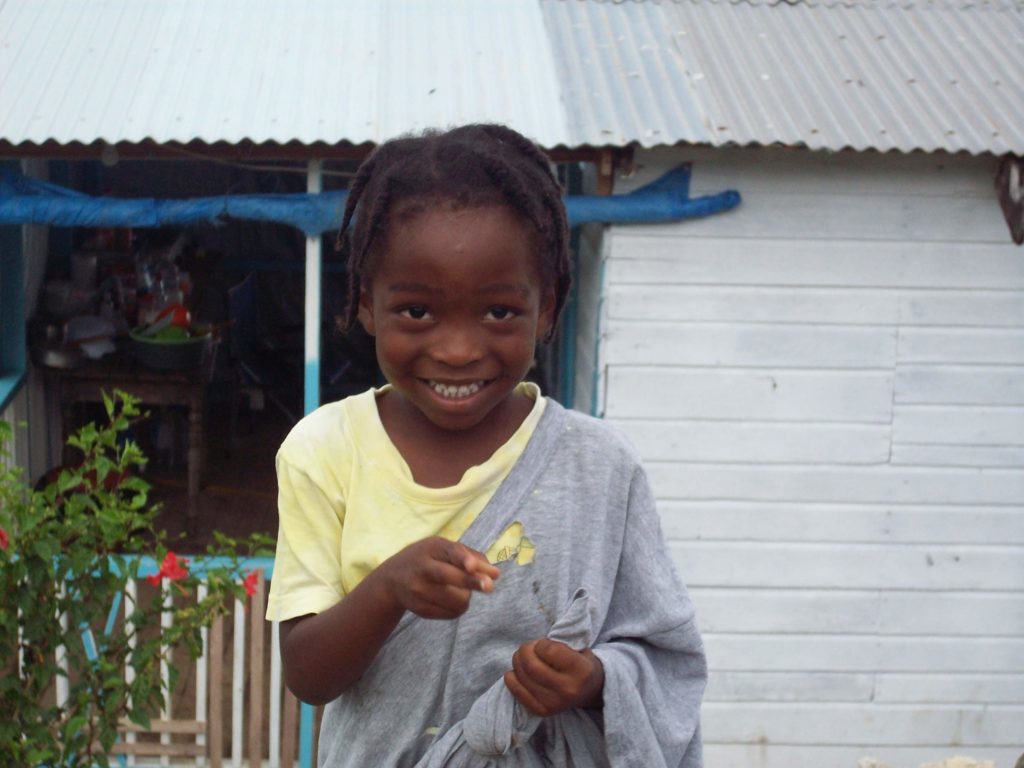 A little Jamaican boy smiles big for the camera